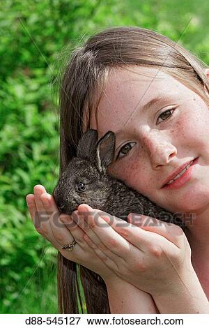 Stock Photo - Girl with rabbit. Fotosearch