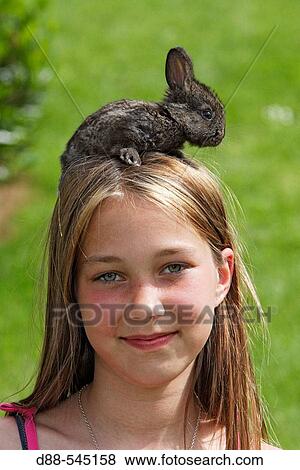 Girl with rabbit View Large Photo Image Stock Photo - Girl with rabbit. Fotosearch