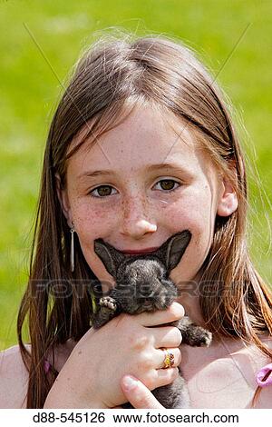 Girl with rabbit View Large Photo Image Stock Photograph - Girl with rabbit. Fotosearch