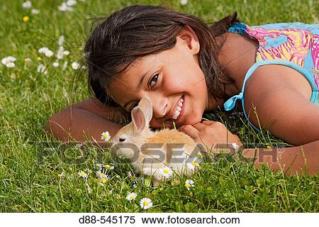 Stock Photography - Girl with rabbit. Fotosearch