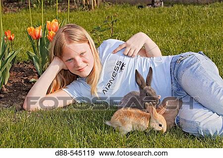 Girl with rabbits View Large Photo Image Stock Photo - Girl with rabbits. Fotosearch
