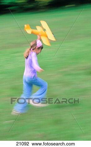Girl with toy airplane View Large Photo Image Stock Image - Girl with toy airplane. Fotosearch