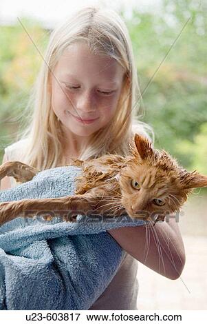 Stock Photo - Girl with washed cat.. Fotosearch