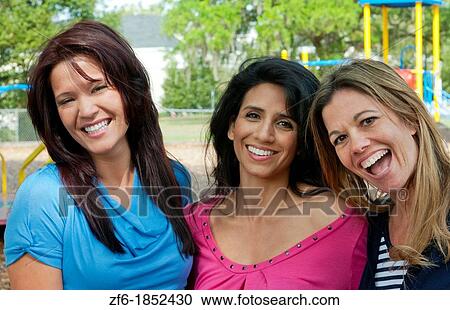 Girlfriends having fun in park aged 30s laughing and excitement in outdoors playground buddies View Large Photo Image Stock Image - Girlfriends having fun in park aged 30s laughing and excitement in outdoors playground buddies. Fotosearch