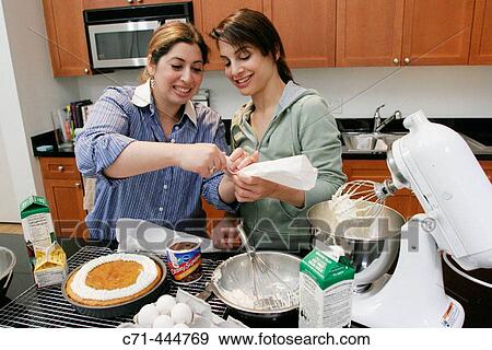 Girlfriends making cake View Large Photo Image Stock Photo - Girlfriends making cake. Fotosearch