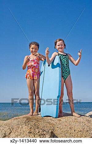 Girlfriends posing at the beach View Large Photo Image Stock Image - Girlfriends posing at the beach. Fotosearch