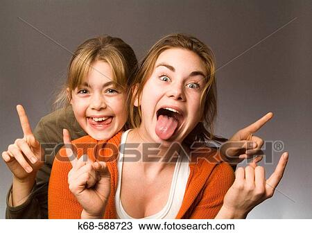 Girls, 10 and 15 playing, making faces View Large Photo Image Stock Image - Girls, 10 and 15 playing, making faces. Fotosearch
