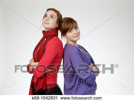 Girls, 14 and 18 in studio View Large Photo Image Stock Image - Girls, 14 and 18 in studio. Fotosearch