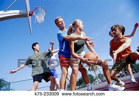 Stock Photo - Girls and boys playing basketball. Fotosearch