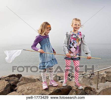 Stock Photo - Girls at the beach fishing, Akranes, Iceland. Fotosearch