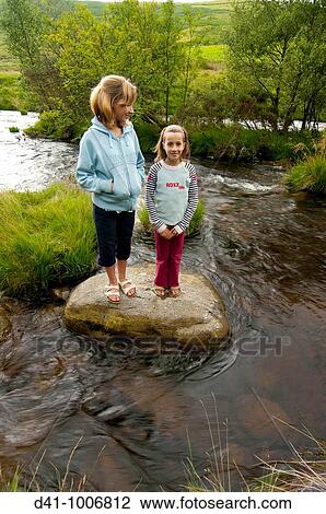 girls children on rock in river wales View Large Photo Image Stock Image - girls children on rock in river wales. Fotosearch