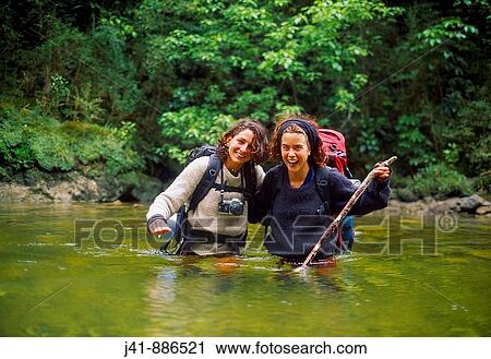 Girls cross the Fox River Paparoa National Park New Zealand View Large Photo Image Stock Image - Girls cross the Fox River Paparoa National Park New Zealand. Fotosearch