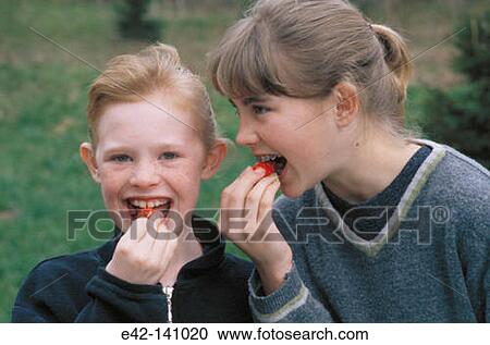Girls eating strawberries View Large Photo Image Stock Image - Girls eating strawberries. Fotosearch