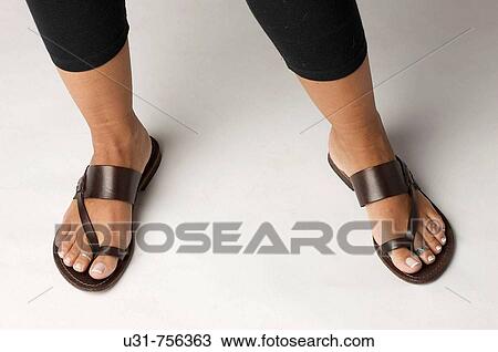 Girl's feet wearing sandals View Large Photo Image Stock Image - Girl's feet wearing sandals. Fotosearch