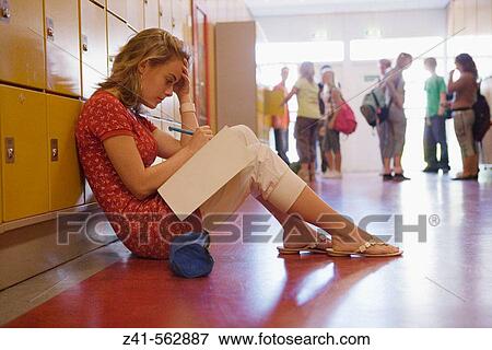Stock Photo - Girls is making homework in the hallway.. Fotosearch