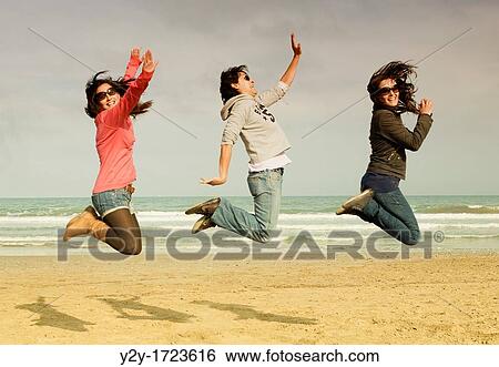 Girls jumping at the beach, in Valencia city, Comunidad Valenciana, Spain View Large Photo Image Stock Photograph - Girls jumping at the beach, in Valencia city, Comunidad Valenciana, Spain. Fotosearch