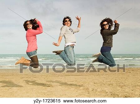 Girls jumping at the beach, in Valencia city, Comunidad Valenciana, Spain View Large Photo Image Stock Photography - Girls jumping at the beach, in Valencia city, Comunidad Valenciana, Spain. Fotosearch