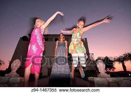 Stock Photography - Girls jumping outdoors. Fotosearch