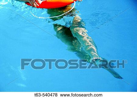 girls lower half of body in swimming pool, with orange lifesaver View Large Photo Image Stock Photo - girls lower half of body in swimming pool, with orange lifesaver. Fotosearch