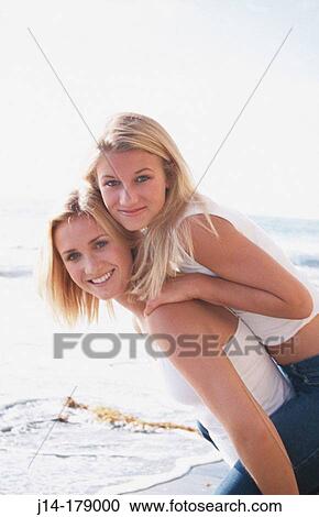 Stock Image - Girls on beach. Fotosearch