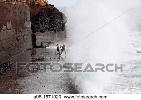 girls playing at the beach and have fun with the spray of waves, Madeira, Portugal, Europe. View Large Photo Image Stock Image - girls playing at the beach and have fun with the spray of waves, Madeira, Portugal, Europe.. Fotosearch