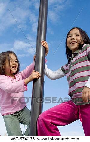 Stock Photography - Girls playing on the playground. Fotosearch