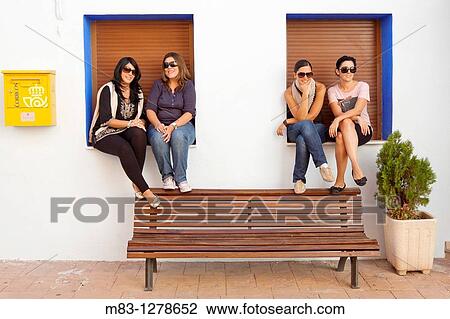 Girls posing in bench, Popular festivities in Carricola, Valencia View Large Photo Image Stock Image - Girls posing in bench, Popular festivities in Carricola, Valencia. Fotosearch