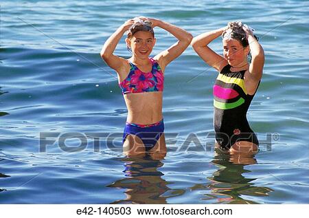 Girls shampooing their hair View Large Photo Image Stock Image - Girls shampooing their hair. Fotosearch