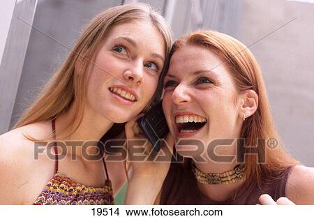 Picture - Girls talking on cellular. Fotosearch