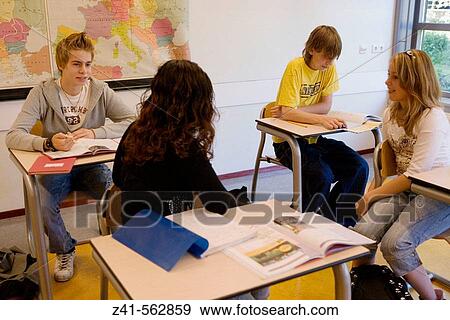 Stock Photo - Girls talking to boys in the classroom. Fotosearch