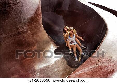 Girls tobogganing Gulliver Park. Turia Riverbed, Valencia, Spain View Large Photo Image Stock Photograph - Girls tobogganing Gulliver Park. Turia Riverbed, Valencia, Spain. Fotosearch