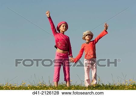 Stock Photo - girls waving on ridge.. Fotosearch