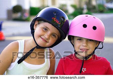 Stock Photograph - girls with bike helmets. Fotosearch