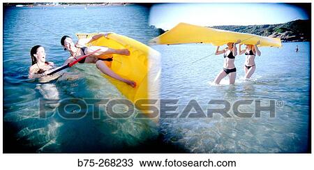 Girls with canoe at the beach View Large Photo Image Stock Image - Girls with canoe at the beach. Fotosearch