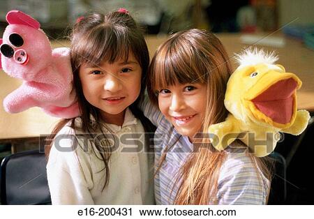 Stock Image - girls with puppets. Fotosearch