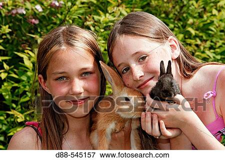 Girls with rabbits View Large Photo Image Stock Photo - Girls with rabbits. Fotosearch