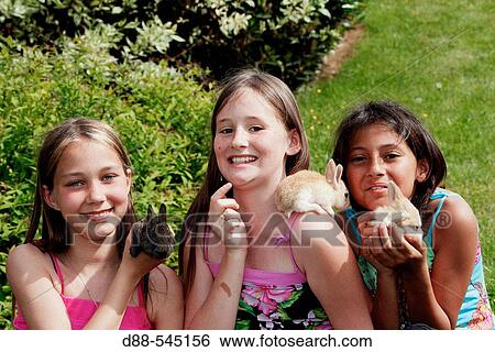 Girls with rabbits View Large Photo Image Stock Photograph - Girls with rabbits. Fotosearch