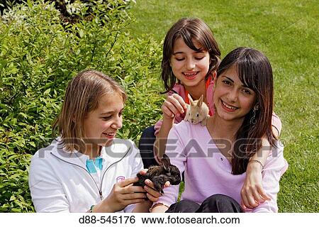 Girls with rabbits View Large Photo Image Stock Photograph - Girls with rabbits. Fotosearch