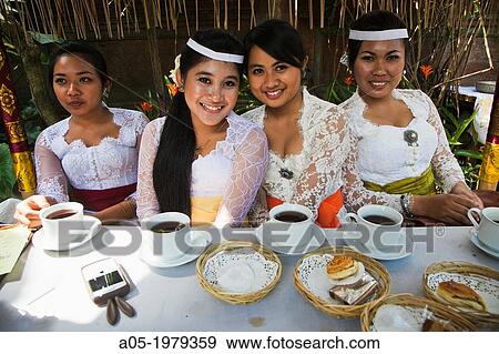 Girls with traditional dress drinking coffee in a ceremony, Ubud, Bali, Indonesia. View Large Photo Image Stock Photo - Girls with traditional dress drinking coffee in a ceremony, Ubud, Bali, Indonesia.. Fotosearch