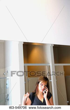 girl/woman in bathroom on cellphone View Large Photo Image Stock Photograph - girl/woman in bathroom on cellphone. Fotosearch