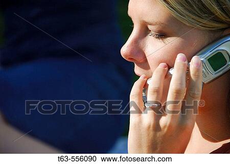 girl/woman talking on cell phone, outdoors View Large Photo Image Stock Image - girl/woman talking on cell phone, outdoors. Fotosearch