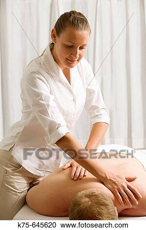 Stock Image - Giving a back massage.. Fotosearch