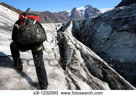 Glacier guide cutting steps in Vatnajokull glacier Iceland View Large Photo Image Stock Image - Glacier guide cutting steps in Vatnajokull glacier Iceland. Fotosearch