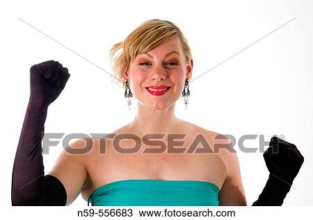 Glamorously dressed young woman punching the air with excitement. View Large Photo Image Stock Image - Glamorously dressed young woman punching the air with excitement.. Fotosearch