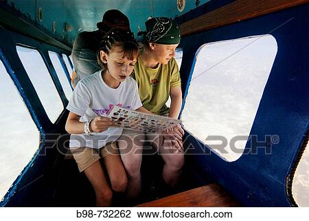 Glass bottom boat at Gumbalimba Park in Roatan, mother and daughter enjoy ride, Honduras View Large Photo Image Stock Image - Glass bottom boat at Gumbalimba Park in Roatan, mother and daughter enjoy ride, Honduras. Fotosearch