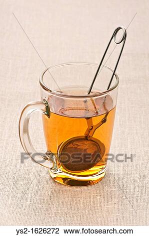 Glass cup with tea and tea strainer View Large Photo Image Stock Image - Glass cup with tea and tea strainer. Fotosearch