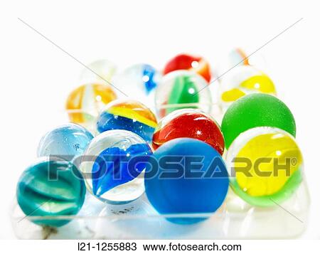 Glass marbles in a plastic box, white background View Large Photo Image Stock Image - Glass marbles in a plastic box, white background. Fotosearch