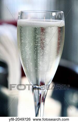 Glass of champagne indoors. View Large Photo Image Stock Photograph - Glass of champagne indoors.. Fotosearch