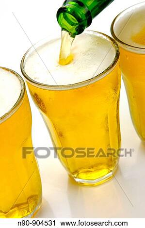 Glasses of beer isolated against a white background View Large Photo Image Stock Image - Glasses of beer isolated against a white background. Fotosearch