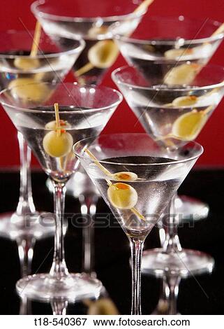 Stock Photo - glasses of martini with olive. Fotosearch